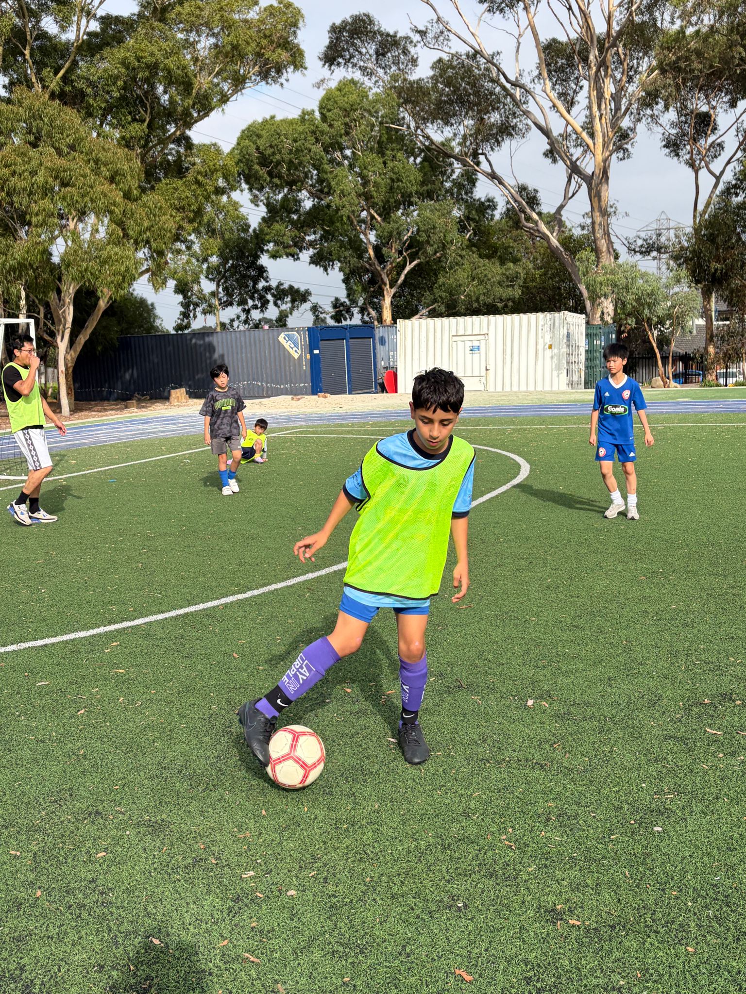 Elevate Football Academy player dribbling on synthetic pitch