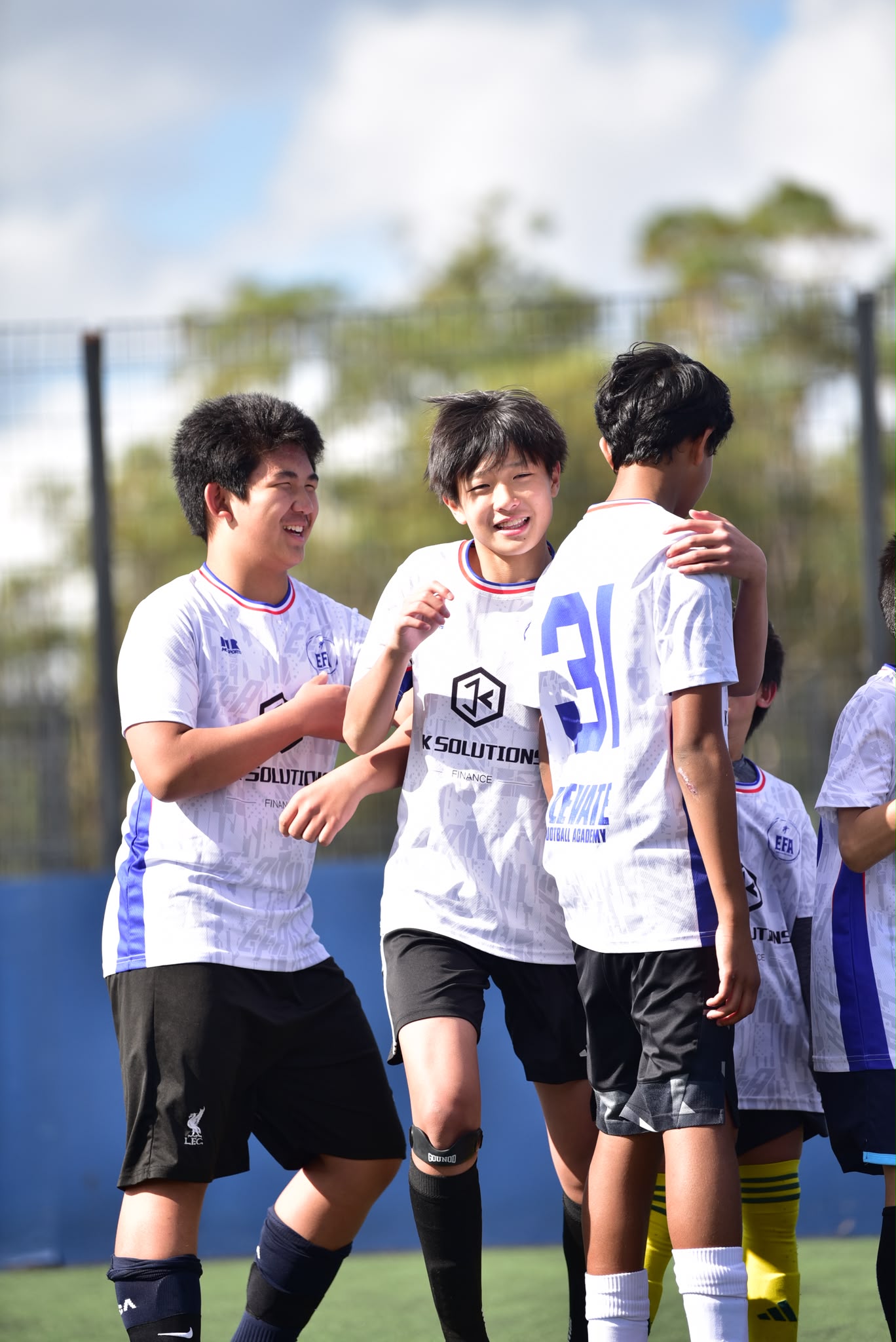 EFA teammates laughing together on the pitch