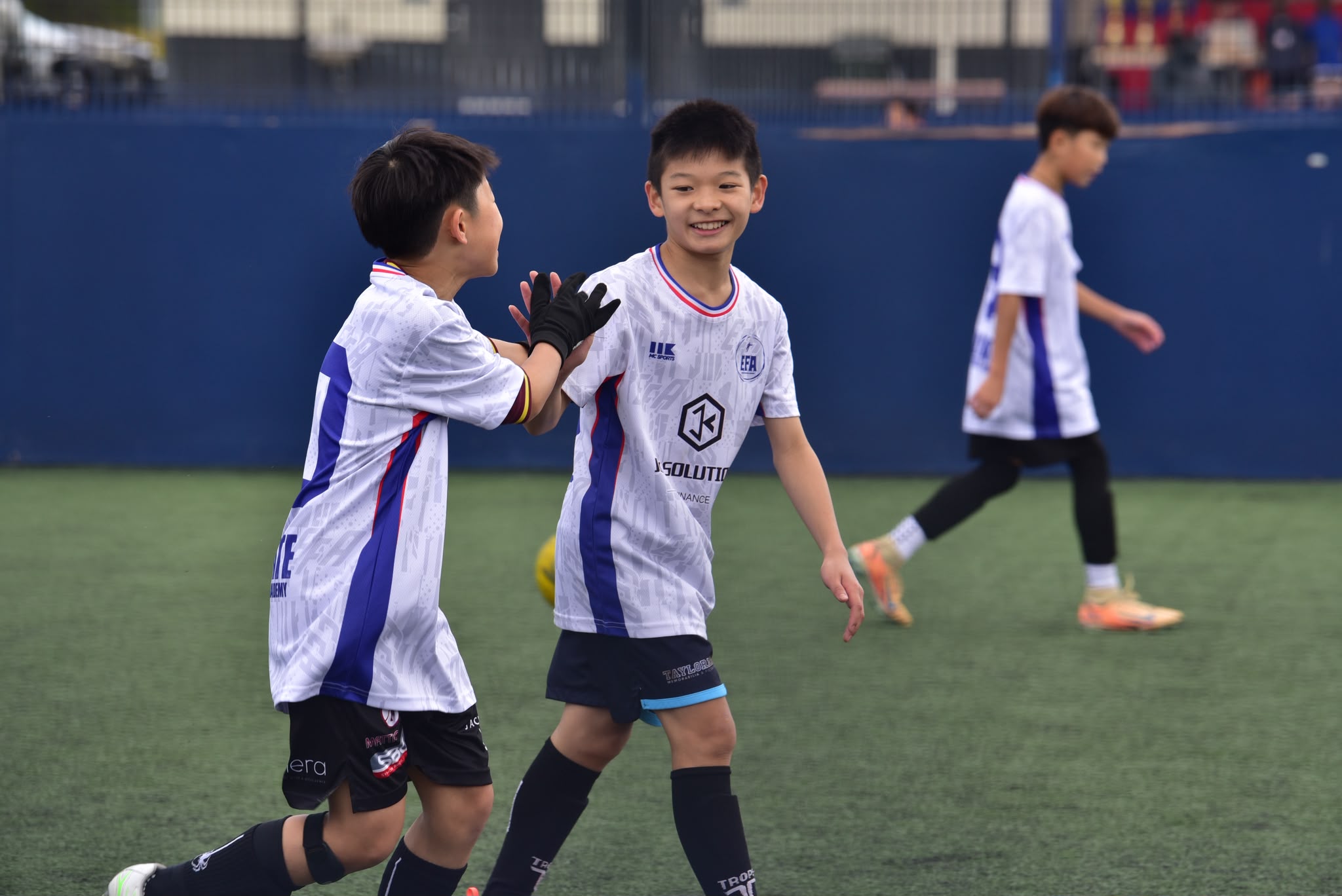 Two EFA players high-fiving after a goal